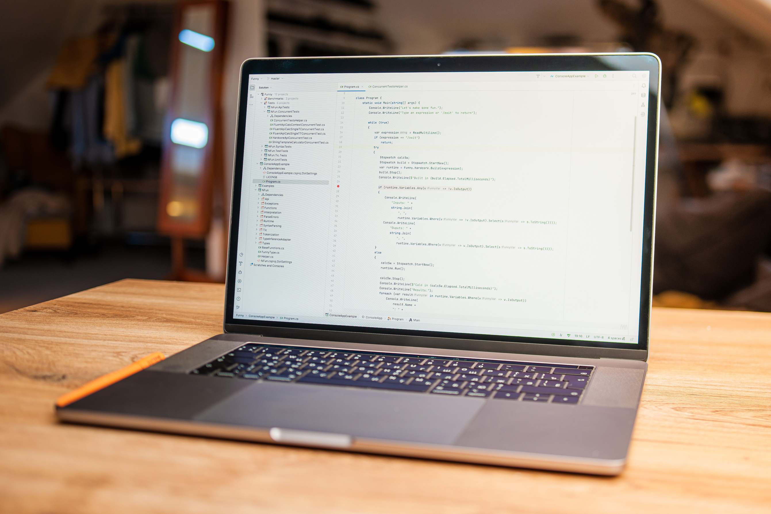 Computer monitor showing application interface code on a desk — open laptop with visible code on screen on a wooden desk in a modern workspace